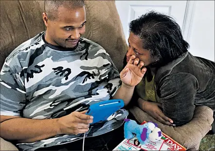  ?? DISPATCH ?? BROOKE LAVALLEY Jason and Susan Evans share a tender moment as he wipes a tear from his mother’s face during a supervised visit. Since getting a new guardian, Jason has lost almost half of his body weight.