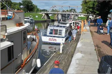  ?? PHOTOS BY NICHOLAS BUONANNO — NBUONANNO@ TROYRECORD. COM ?? People enjoy looking at many of the different tugboats on display at the Waterford Tugboat Roundup Saturday.