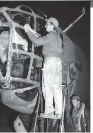  ??  ?? Right: A crewman cleans the Plexiglas of the B-24D of the 512th BS the night before the Ploesti mission. (Photo via Jack Cook)