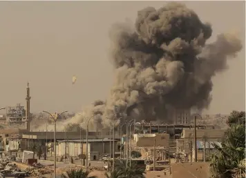  ?? (Reuters) ?? SMOKE RISES after an air strike during fighting between members of the Syrian Democratic Forces and Islamic State in Raqqa earlier this month.