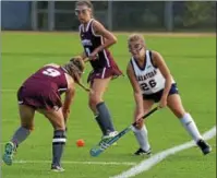  ??  ?? Saratoga Springs' Sophie Hieronymi (26) defends as Burnt Hills-Ballston Lake's Sadie Mitchell (9) and Sydney Plemenik (7) look on in a Suburban Council field hockey game Wednesday at Saratoga Springs High School.