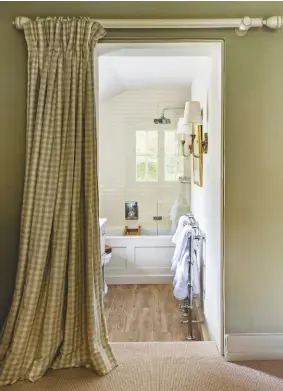  ??  ?? EN SUITE A curtain at the entrance is a space-saving idea.
For similar curtain fabric, try Ian Mankin’s Suffolk Check in Sage, £29.50m. The Chatsworth heated towel rail, £199.95, Victorian Plumbing, is identical