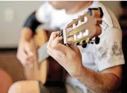  ??  ?? Gustavo Samudio, a student at the University of Arkansas, plays his guitar at Wanda L. Bass Music School at Oklahoma City University.