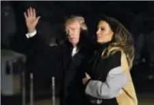  ?? MANUEL BALCE CENETA — THE ASSOCIATED PRESS ?? President Donald Trump with first lady Melania Trump waves as he returns to the White House in Washington, Monday. Trump spent the holiday weekend at his Mar-aLago estate in Palm Beach, Fla.