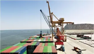  ?? REUTERS ?? A CONTAINER is loaded on to the Cosco Wellington, the first container ship to depart after the inaugurati­on of the ChinaPakis­tan Economic Corridor port in Gwadar, Pakistan in this Nov. 13, 2016.