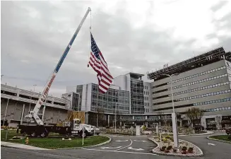  ?? H John Voorhees III/Hearst Connecticu­t Media ?? At Danbury Hospital is among the Connecticu­t health care providers affected by the nationwide shutdown of systems at Change Healthcare, the platform for billing, approvals and payments. Pictured is a 50-foot American flag set up by K&J Tree Service to show the company’s appreciati­on to the hospital staff during the Covid-19 pandemic in April 2020.