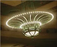  ??  ?? An enormous chandelier hangs from the ornately painted ceiling in the Schiewetz Auditorium within the Dayton Masonic Center.