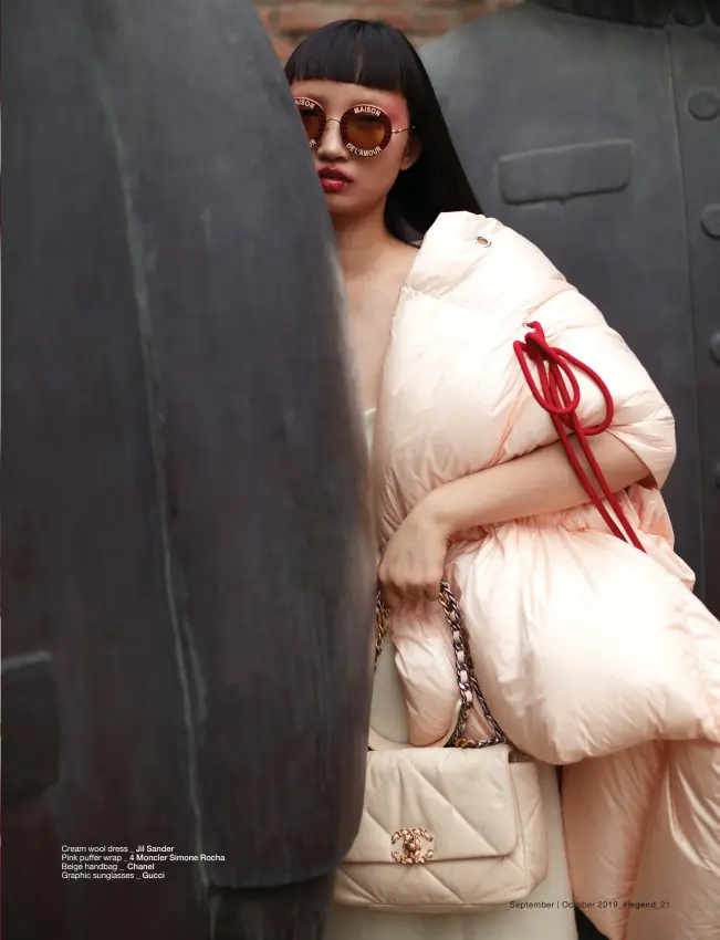  ??  ?? Cream wool dress _ Jil Sander Pink puffer wrap _ 4 Moncler Simone Rocha Beige handbag _ Chanel Graphic sunglasses _ Gucci