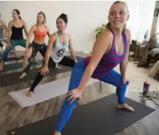  ?? KJELL REDAL/THE SEATTLE TIMES ?? One trap-yoga class guided participan­ts through traditiona­l poses such as downward dog set to gritty trap music. Then came the twerking.