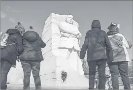  ?? BILL O’LEARY — THE WASHINGTON POST ?? People gather at the Martin Luther King Jr. Memorial on the National Mall on Saturday. Monday’s holiday honors the civil rights leader.