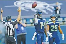  ?? JOHN FROSCHAUER/ASSOCIATED PRESS ?? Seattle Seahawks wide receiver DK Metcalf tosses the ball next to running back Travis Homer after Metcalf caught a touchdown pass from Russell Wilson against the Dallas Cowboys on Sunday.