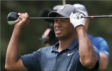  ?? JEFF ROBERSON — THE ASSOCIATED PRESS ?? Tiger Woods reacts to his second shot on the eighth hole during the first round of the PGA Championsh­ip at Bellerive Country Club, Thursday in St. Louis.