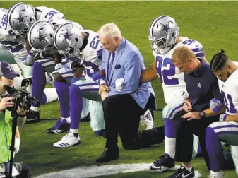  ?? Matt York / Associated Press ?? The Dallas Cowboys, led by owner Jerry Jones, take a knee prior to the national anthem for a Monday night game Sept. 25. Jones recently said that his players will stand for the anthem.