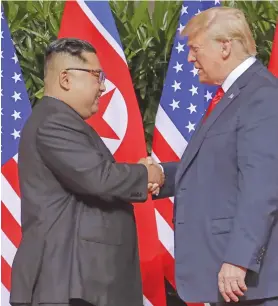  ?? Photo: AP ?? US President Donald Trump meets North Korean leader Kim Jong-un shake hands to kick off their summit.