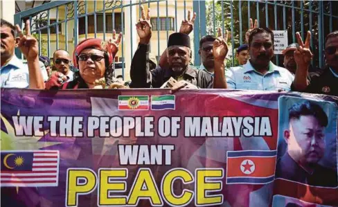  ??  ?? Activists gathering outside the North Korean embassy in Kuala Lumpur recently. Of all places to attack Kim Jong-nam, why did it have to be Malaysia?