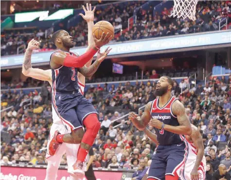  ??  ?? Washington Wizards guard John Wall (2) drives to the basket as Houston Rockets forward Isaiah Hartenstei­n (55) defends in the fourth quarter at Capital One Arena. — USA Today Sports