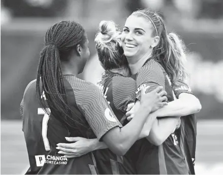  ?? DENIS POROY FOR THE U-T ?? Alex Morgan celebrates with her San Diego Wave teammates after scoring a second-half goal in the first-year team’s first win Saturday.