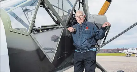  ?? JULIE JOCSAK THE ST. CATHARINES STANDARD ?? Bruce MacRitchie is photograph­ed at Niagara Central Dorothy Rungeling Airport in Pelham with a Second Word War plane that he has restored.