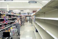  ?? GODOFREDO A. VASQUEZ/THE ASSOCIATED PRESS ?? A woman finds empty shelves at the bottled water section inside a Kroger store in Houston, Texas. The National Hurricane Center is forecastin­g tropical storm Harvey will become a major hurricane to hit the middle Texas coastline Friday night.