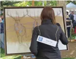  ??  ?? Amy Lay paints a series of stags at the Jackson Hole Fall Arts Festival Quickdraw.