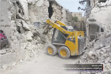  ?? Local Council of Aleppo City ?? A bulldozer clears debris after air strikes in September in a photo from the Aleppo council. Hundreds have since died in fighting.