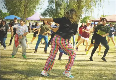  ?? ?? Families turned dancers mirror the Zumba instructor.