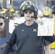  ?? ASSOCIATED PRESS FILE PHOTO ?? Coach Jim Harbaugh and Michigan have returned to the AP Top 25poll at No. 23. Michigan begins the season Oct. 24.