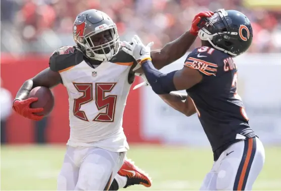  ?? | CHRIS O’MEARA/ AP ?? Bears cornerback Marcus Cooper tries to stop Buccaneers running back Peyton Barber, who had 47 yards on 10 carries, in the second half Sunday.
