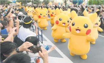  ?? — AFP photo ?? In this file show performers dressed as Pikachu, the popular animation Pokemon series character, perform in the Pikachu parade in Yokohama.