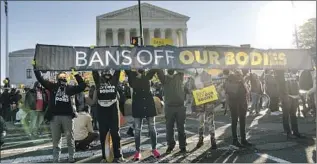  ?? Kent Nishimura Los Angeles Times ?? ABORTION RIGHTS advocates demonstrat­e in front of the Supreme Court in December.