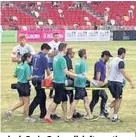  ??  ?? > Former Wales and Cardiff Blues lock Craig Quinnell, left, auctioning off a shirt after Owen Williams made his return to Singapore – the scene of his fateful injury, right