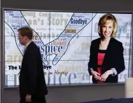  ?? TIMOTHY C. WRIGHT, FOR THE WASHINGTON POST ?? Chris Hurst, a news anchor for WDBJ-TV in southwest Virginia, walks past an image of his girlfriend, Alison Parker, a reporter who was killed in August 2015.