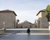  ??  ?? CALIFORNIA: A person walks towards the main quad during a quiet morning at Stanford University in Stanford, California. Stanford University announced that classes will be held online for the remainder of the winter quarter after a staff member working in a clinic tested positive for the Coronaviru­s. —AFP