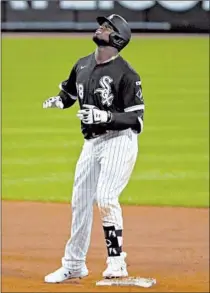  ?? JOHN J. KIM/CHICAGO TRIBUNE ?? Rookies who made big league debuts without family present include Royals pitcher Brady Singer, above, against the Indians on Saturday and the White Sox’s Luis Robert, left, on Friday.