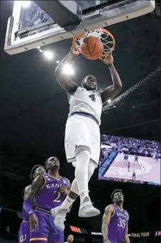  ?? Associated Press ?? Villanova’s Eric Paschall dunks for two of his 24 points in the Wildcats’ 95-79 rout of Kansas in the second semifinal