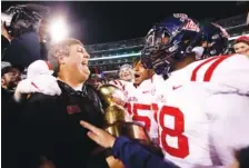  ?? ASSOCIATED PRESS FILE PHOTO ?? Mississipp­i coach Matt Luke, left, celebrates with players following their 31-28 win over Mississipp­i State in the Nov. 23 Egg Bowl in Starkville, Miss.