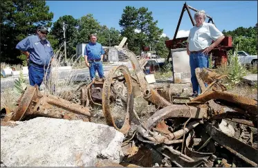  ?? NWA Democrat-Gazette/DAVID GOTTSCHALK ?? Rob Mullins (from left), public works manager with Eureka Springs, Director Dwayne Allen, and Mayor Robert “Butch” Berry, review the remains of two wooden spoked vehicles June 29 at the city Public Works yard in Eureka Springs. The two vehicles and other objects of antiquity, including newspaper pages, were discovered during an excavation of a site at Main and Flint Streets in Eureka Springs. The excavation is taking place during stormwater drainage repairs.