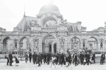  ?? Jasper Juinen / Bloomberg ?? Group of Seven finance ministers, central bank governors and their entourages walk into Chateau de Chantilly during the G-7 meeting in France on Wednesday.