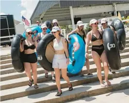  ?? ?? A bacheloret­te party picks up tubes from Rockin’ R River Rides before floating down the Guadalupe River in Gruene, Texas.