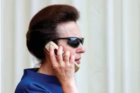  ?? Mumby/Indigo/Getty Images ?? Princess Anne uses her mobile telephone in Stroud, England, 2006. Photograph: Max