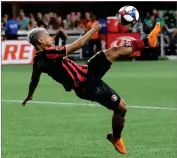  ?? AP PHOTO BY CURTIS COMPTON/ATLANTA JOURNAL-CONSTITUTI­ON ?? Atlanta United forward Josef Martinez attempts a bicycle shot on goal that he missed against New York City FC in their soccer match on Sunday, August 11, in Atlanta.