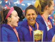  ?? Jayne Kamin-Oncea Getty Images ?? CARLI LLOYD, center, agrees with the decision to postpone the Olympics. “People’s lives have been lost,” she said.