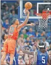  ?? TERRY/ THE OKLAHOMAN] ?? Oklahoma City's Terrance Ferguson (23) taps the ball back out beside LA's Paul George (13) during Sunday night's game. Ferguson's defense on George was a key factor in the Thunder's 118-112 win. [BRYAN