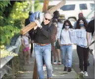  ?? Bryan Haeffele/ H earst Connecticu­t Media file photo ?? Hundreds of people gathered in Darien for a walk organized by the town’s clergy to mourn the death of George Floyd and those lost to COVID-19, a replacemen­t of last year’s Good Friday Cross Walk.