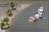  ?? THE ASSOCIATED PRESS ?? Boats are partially submerged in the wake of Hurricane Irma Monday in Key Largo, Fla.