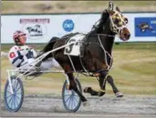  ?? ASSOCIATED PRESS FILE ?? In this file photo, a horse and driver make their way to the finish line during qualifiers at Vernon Downs on Tuesday, April 14, 2015.