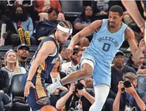  ?? CHRISTINE TANNOUS/USA TODAY SPORTS ?? Memphis Grizzlies guard De'anthony Melton and New Orleans Pelicans guard Jose Alvarado battle for the ball during the second half of a game at Fedexforum..