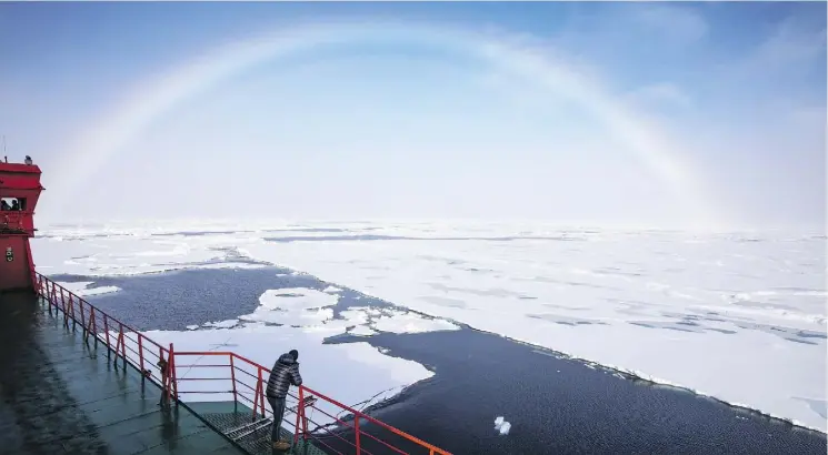  ?? PHOTOS: MARK CHILVERS/THE WASHINGTON POST ?? A rainbow spans the Arctic sky in front of the Russian icebreaker 50 Let Pobedy (or 50 Years of Victory in English).