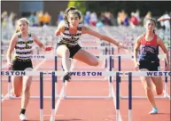  ?? Christian Abraham / Hearst Connecticu­t Media ?? Joel Barlow’s Mariella Schweitzer clears the final hurdle for first place at the SWC championsh­ips Wednesday.