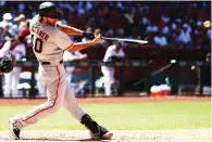  ?? (Reuters) ?? SAN FRANCISCO GIANTS pitcher Madison Bumgarner hits a solo home run in the fifth inning against the Arizona Diamondbac­ks – the first of his two dingers in the Giants’ 6-5 season-opening road loss to the D’Backs on Sunday night.